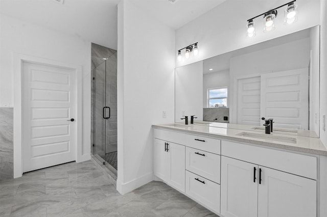 bathroom with a shower with shower door and vanity