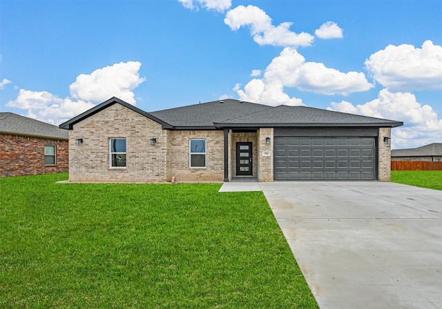 view of front of house featuring a garage and a front yard