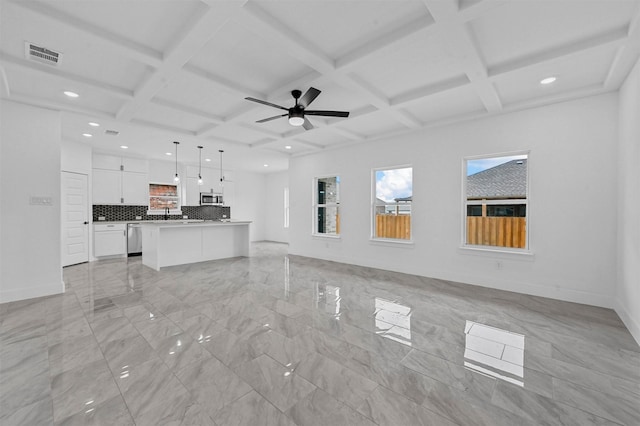 unfurnished living room with coffered ceiling and ceiling fan