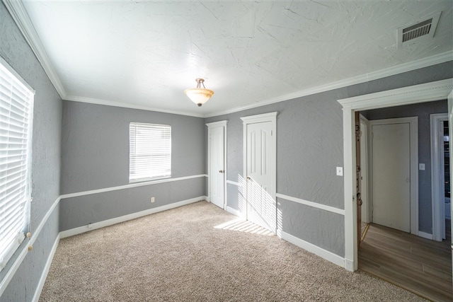 carpeted empty room with ornamental molding