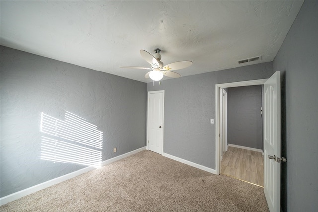 unfurnished bedroom with ceiling fan, carpet floors, and a closet