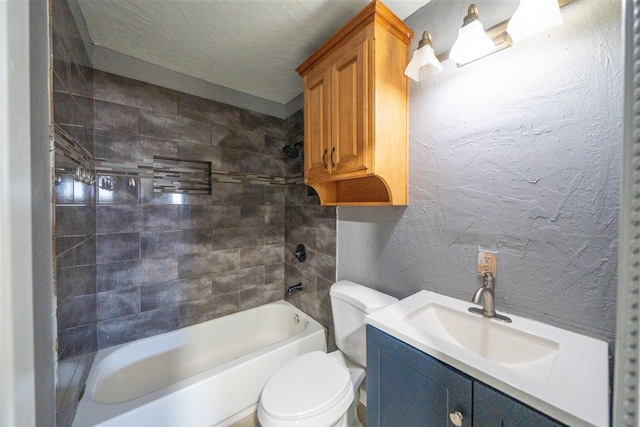 full bathroom with vanity, tiled shower / bath combo, and toilet