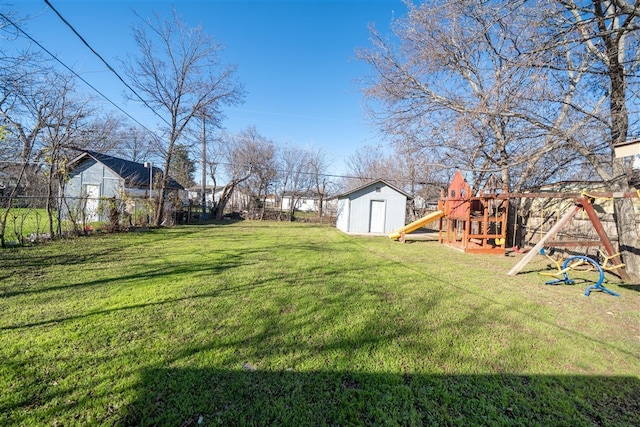 view of yard featuring a playground and a shed