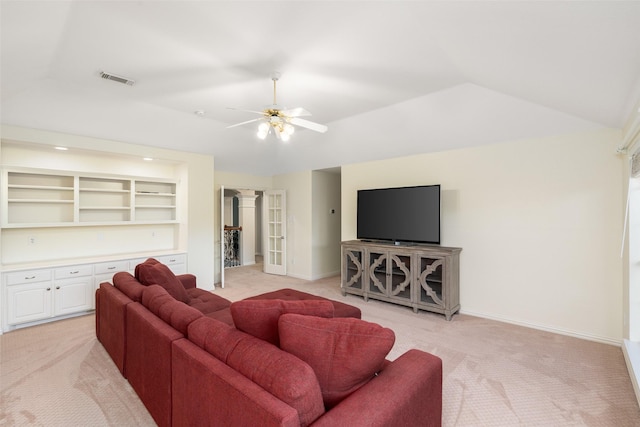 carpeted living room featuring ceiling fan, built in features, and vaulted ceiling