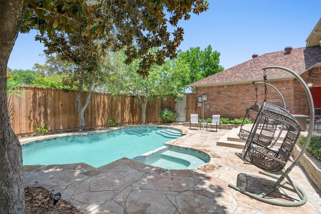 view of swimming pool featuring an in ground hot tub and a patio