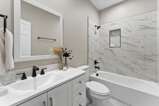 full bathroom featuring vanity, tiled shower / bath combo, and toilet