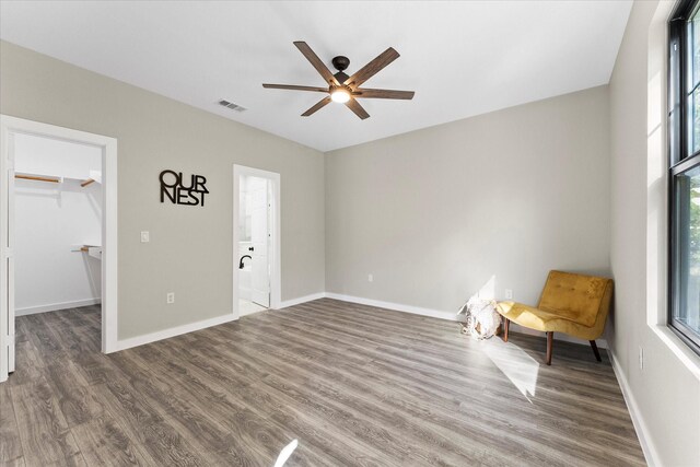 interior space with ceiling fan and dark wood-type flooring