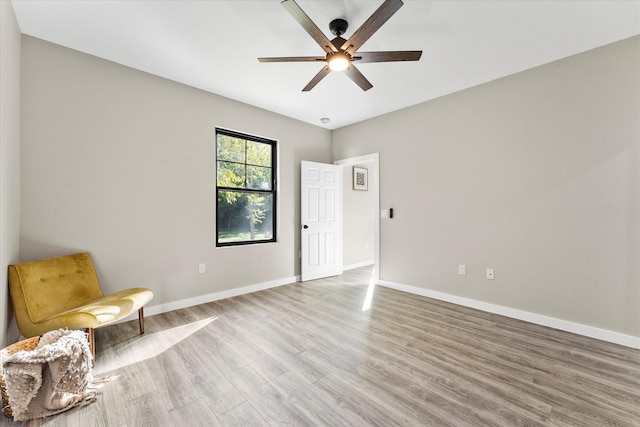 unfurnished room with wood-type flooring and ceiling fan