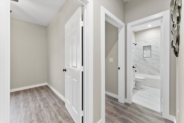 hallway with light hardwood / wood-style flooring