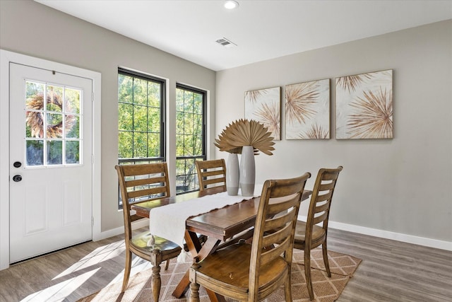 dining space with dark hardwood / wood-style flooring