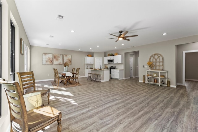 living room featuring ceiling fan and light wood-type flooring