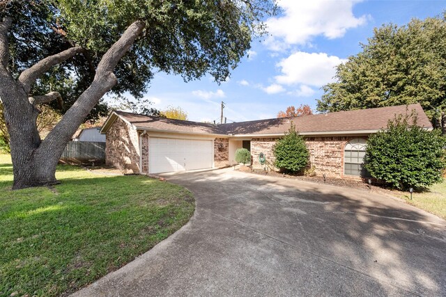 ranch-style house featuring a garage and a front yard