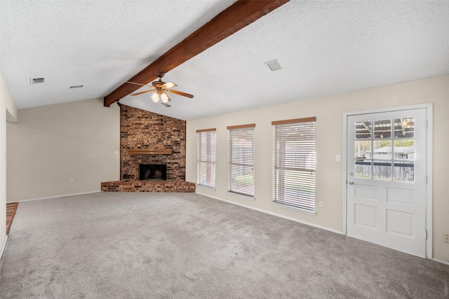 unfurnished living room with carpet, a brick fireplace, a textured ceiling, ceiling fan, and lofted ceiling with beams