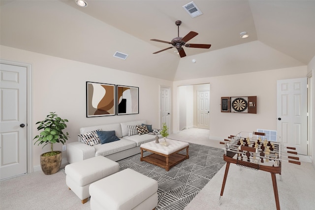 living room featuring vaulted ceiling, light colored carpet, and ceiling fan