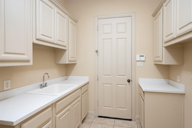 clothes washing area featuring sink and light tile patterned floors