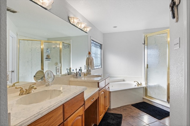 bathroom with tile patterned floors, vanity, and shower with separate bathtub