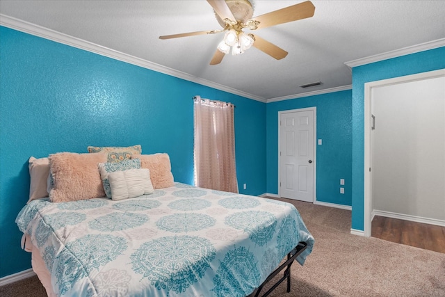 carpeted bedroom with ceiling fan and ornamental molding