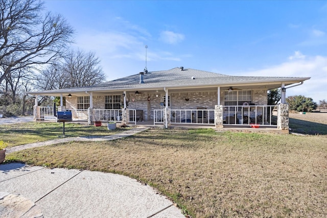 rear view of house with a yard and ceiling fan