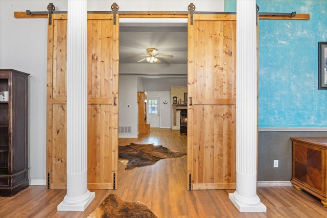 interior space featuring wood-type flooring and a barn door