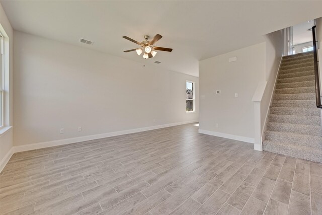 unfurnished living room featuring ceiling fan and light hardwood / wood-style floors