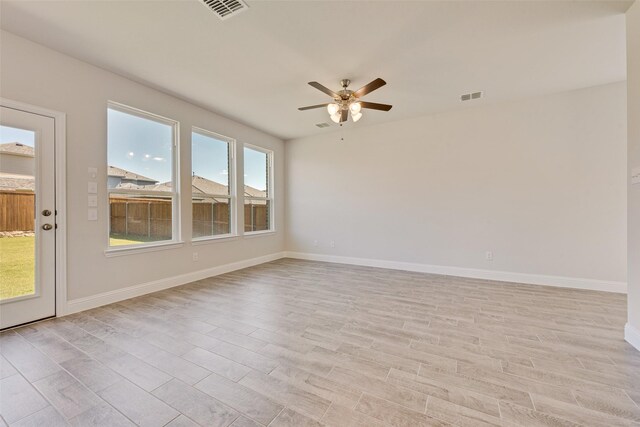 unfurnished room with light wood-type flooring and ceiling fan