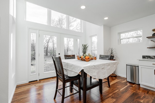 dining room with baseboards, a high ceiling, recessed lighting, dark wood-type flooring, and french doors