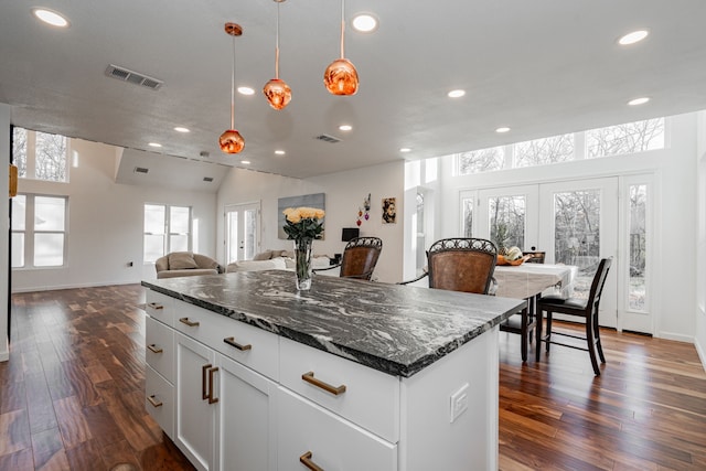 kitchen featuring dark wood-style floors, visible vents, french doors, and open floor plan