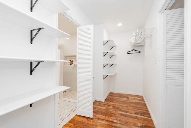 spacious closet with light wood finished floors