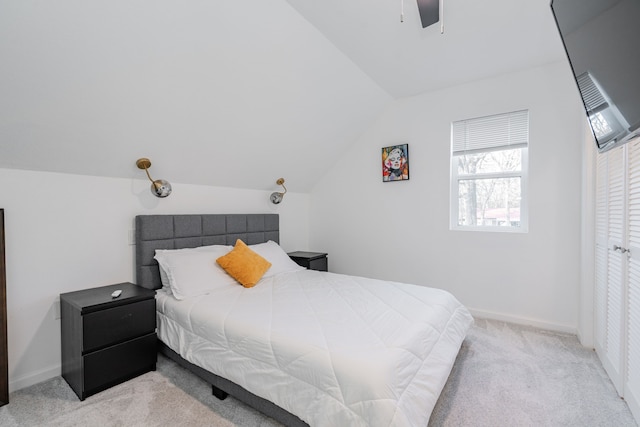 bedroom featuring baseboards, light carpet, ceiling fan, and vaulted ceiling