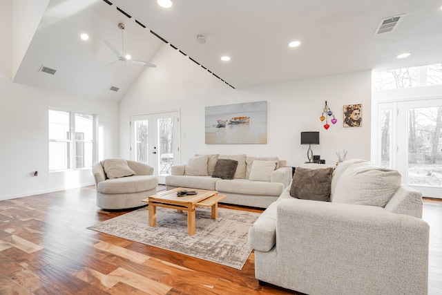 living room with visible vents, high vaulted ceiling, wood finished floors, recessed lighting, and french doors