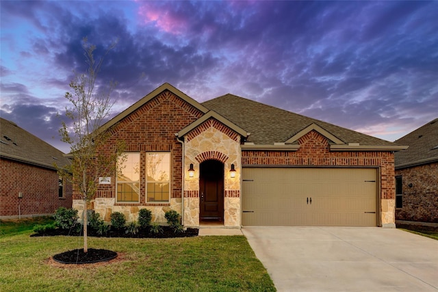 view of front facade with a yard and a garage