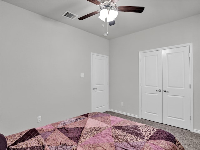 carpeted bedroom with ceiling fan and a closet