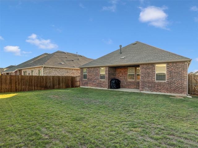 back of property featuring a yard