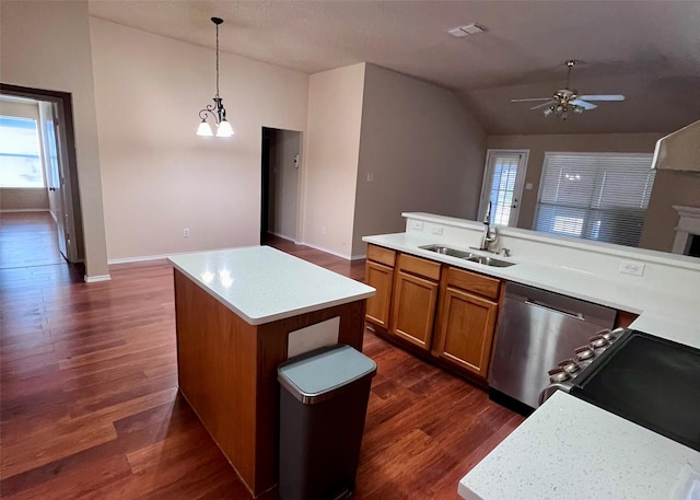 kitchen featuring a center island, ceiling fan with notable chandelier, sink, vaulted ceiling, and decorative light fixtures