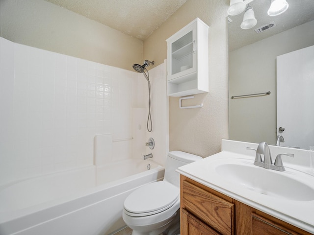 full bathroom with bathing tub / shower combination, vanity, a textured ceiling, and toilet