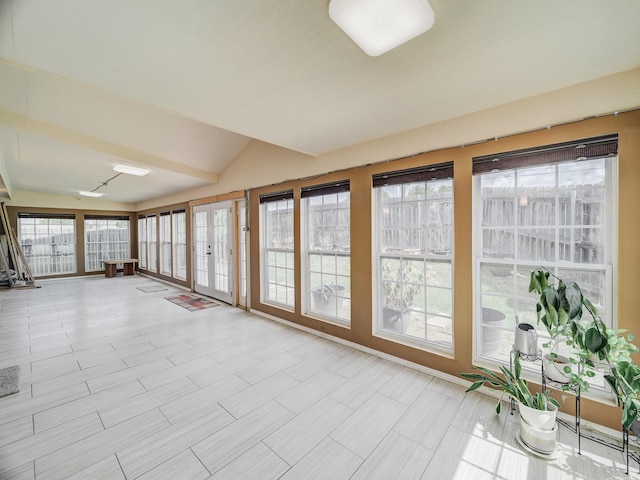 unfurnished sunroom with a healthy amount of sunlight and vaulted ceiling