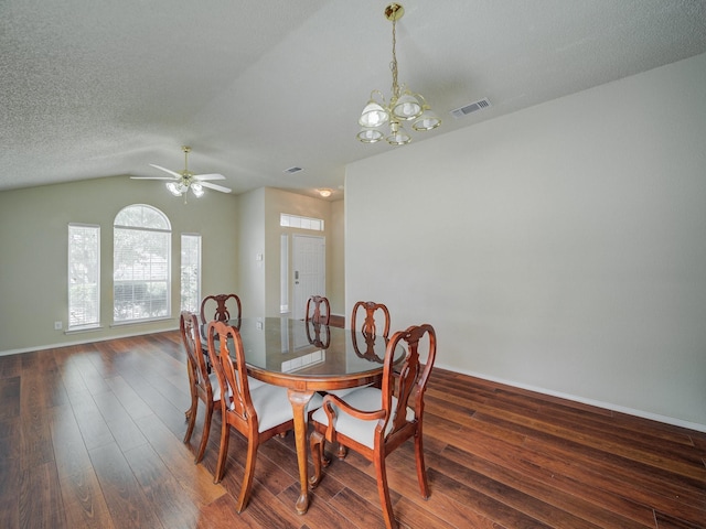 dining room with ceiling fan with notable chandelier, a textured ceiling, dark hardwood / wood-style flooring, and lofted ceiling