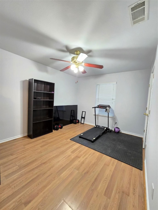 exercise area featuring ceiling fan and light hardwood / wood-style floors