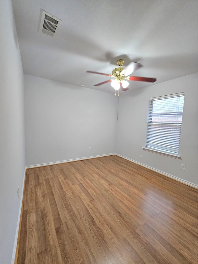 spare room featuring light hardwood / wood-style flooring and ceiling fan