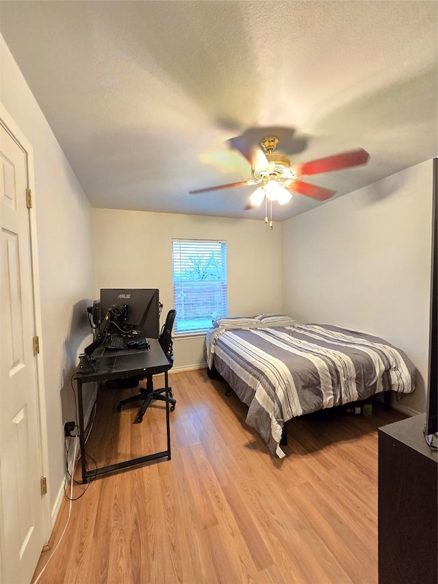 bedroom featuring ceiling fan and light wood-type flooring