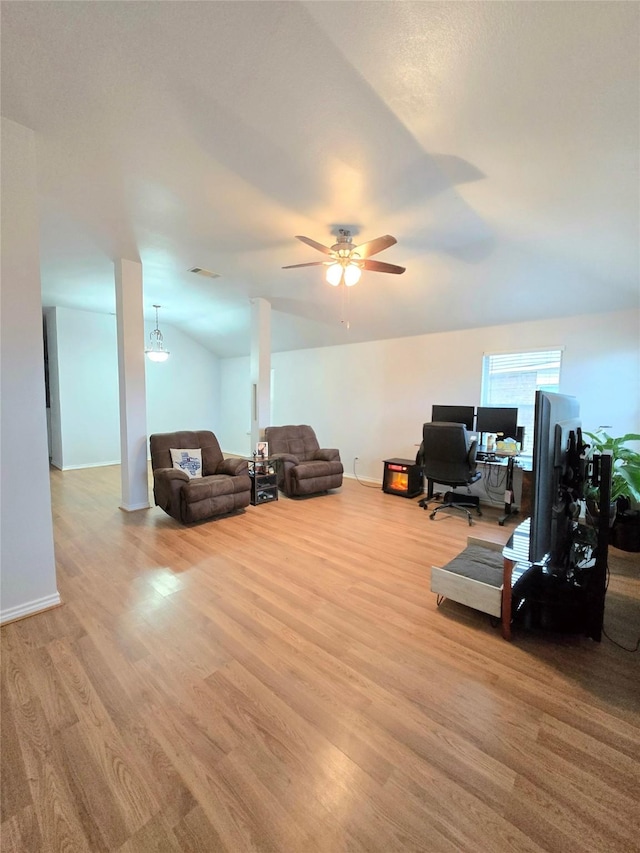 living room with ceiling fan, lofted ceiling, and light hardwood / wood-style floors