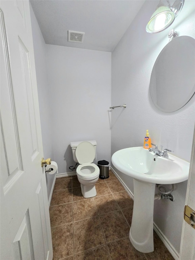 bathroom with tile patterned flooring and toilet