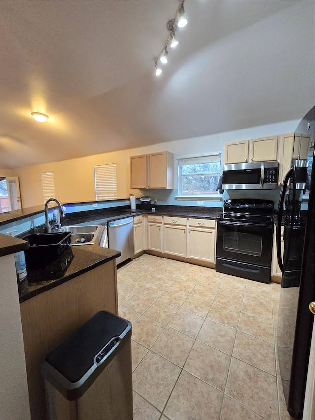 kitchen featuring appliances with stainless steel finishes, light tile patterned floors, light brown cabinetry, and sink