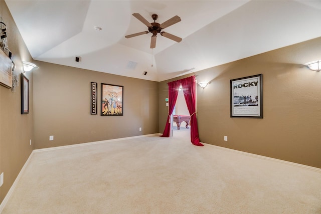 interior space with a raised ceiling, ceiling fan, and lofted ceiling