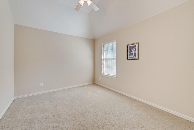 empty room featuring ceiling fan, light colored carpet, and lofted ceiling