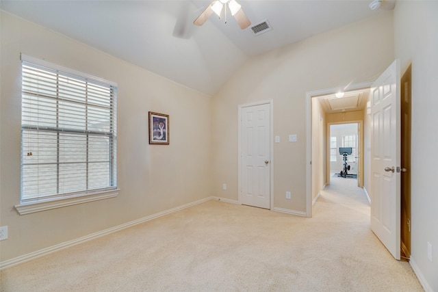 unfurnished room featuring ceiling fan, light carpet, and vaulted ceiling