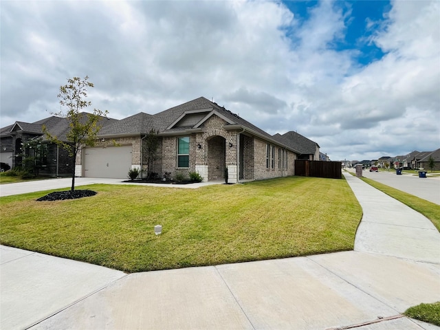 view of front of property with concrete driveway, brick siding, a front lawn, and an attached garage