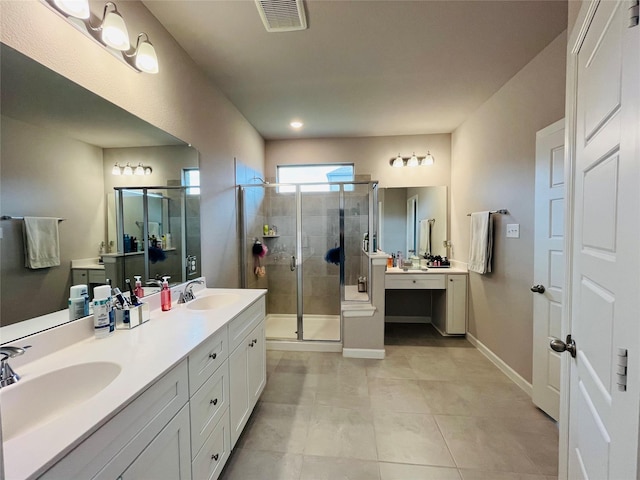 bathroom featuring tile patterned flooring, vanity, and a shower with shower door