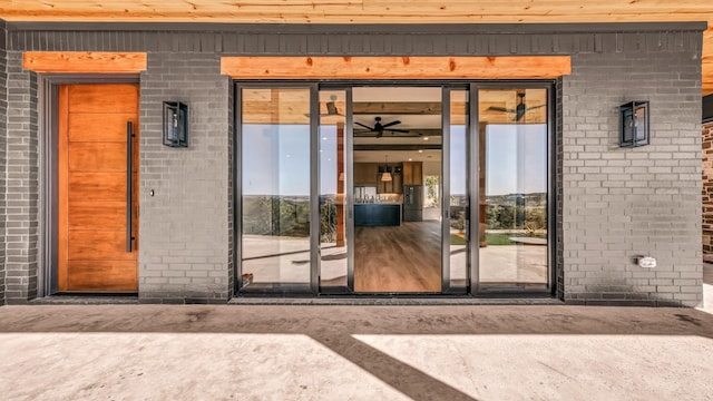 entrance to property featuring brick siding