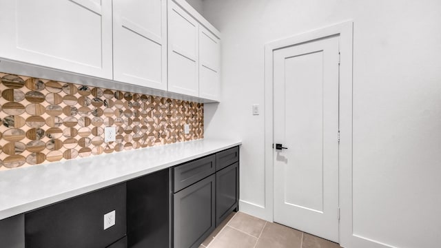 kitchen with white cabinets, light countertops, and light tile patterned floors